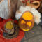 A top down view of the gourd. A candle lights the inside. The top hat sits near. The ghostly hair is attached to the  opening rim. 